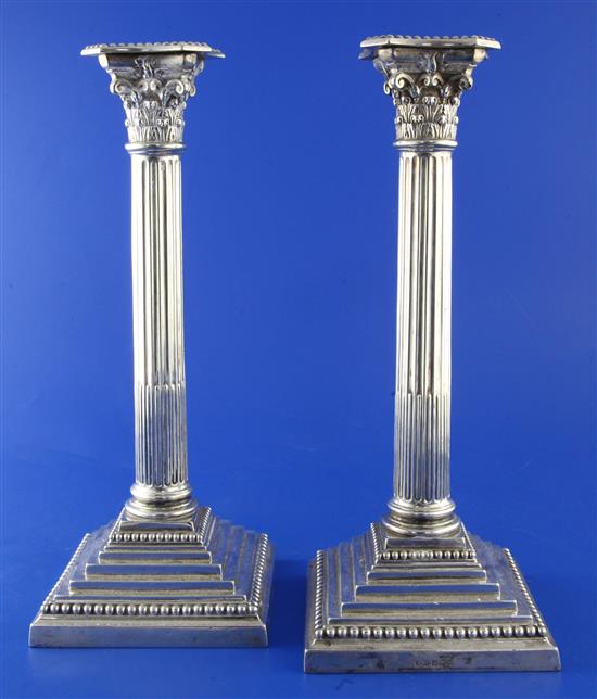 A pair of George V silver corinthian column candlesticks by James Dixon & Sons, weighted.